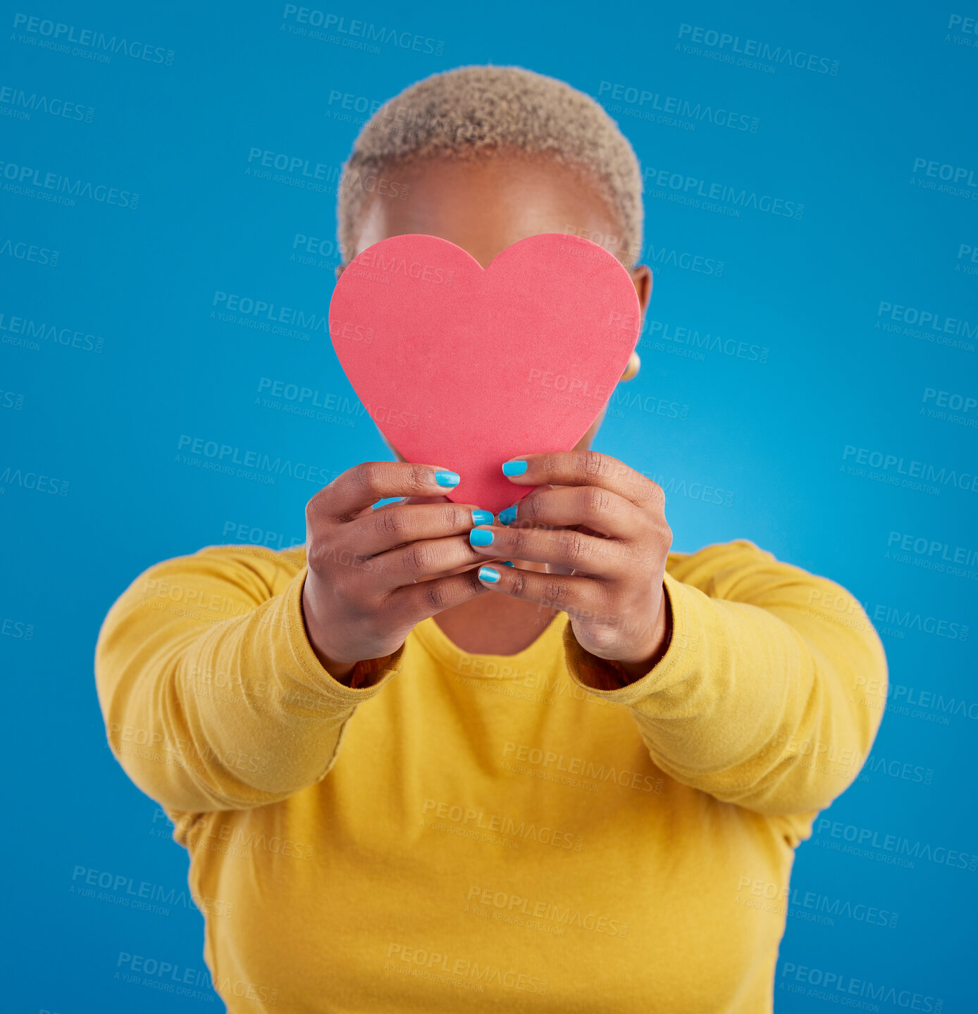 Buy stock photo Paper, heart and cover with black woman in studio for love, date and kindness. Invitation, romance and feelings with female and shape isolated on blue background for emotion, support and affectionate