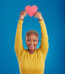 Paper, heart and portrait of black woman in studio for love, date and kindness. Invitation, romance and feelings with female and shape isolated on blue background for emotion, support or affectionate