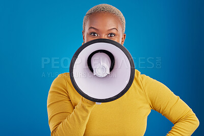 Buy stock photo Megaphone, change and speaker with black woman in studio for awareness, democracy and opinion. Vote, announcement and message with female on blue background for empowerment, strike and choice
