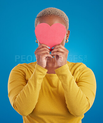 Buy stock photo Paper, heart and hide with black woman in studio for love, date and kindness. Invitation, romance and feelings with female and shape isolated on blue background for emotion, support and affectionate