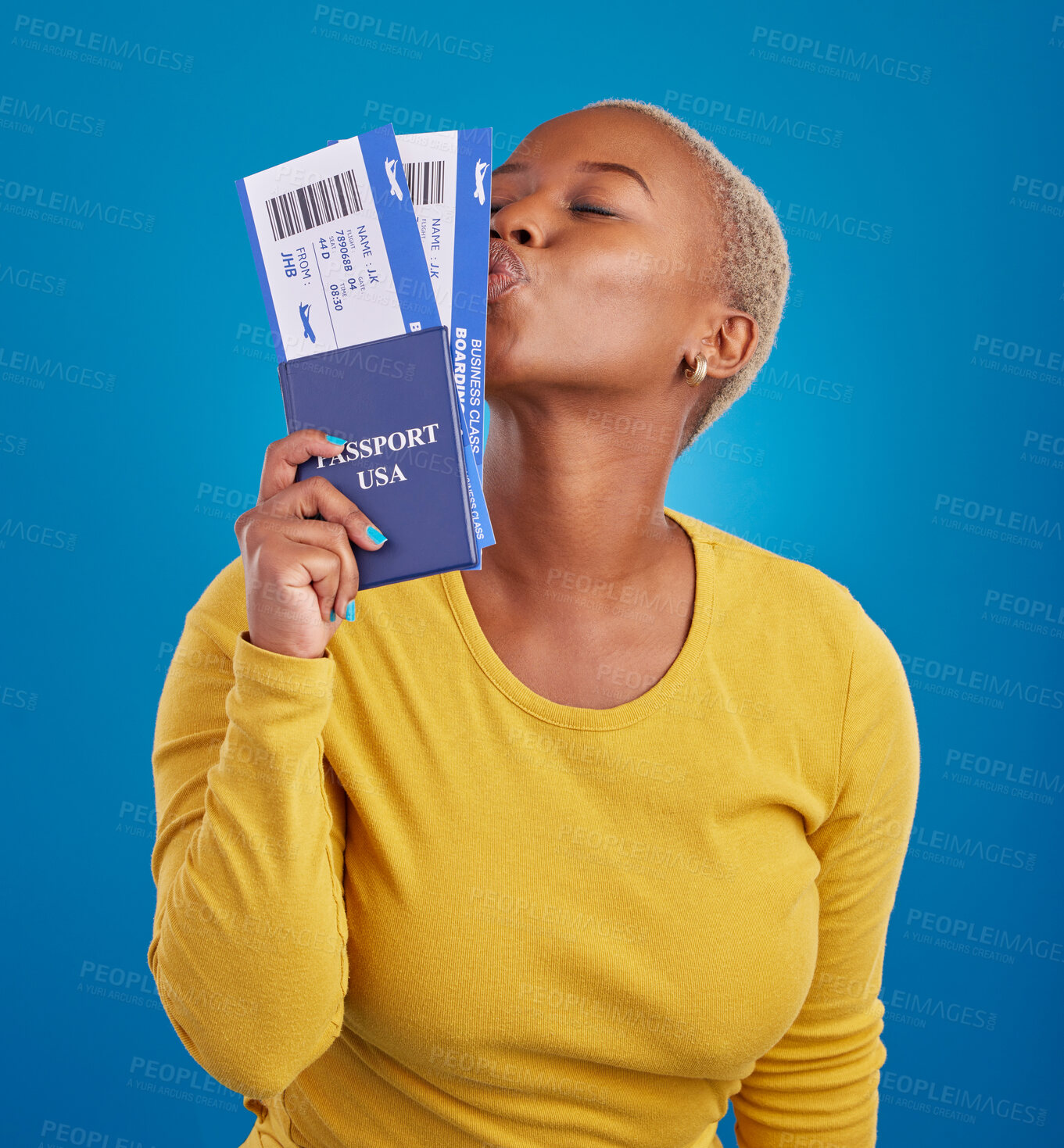Buy stock photo Kiss, travel passport and black woman in studio on blue background for flight documents, tickets and ID. Traveling mockup, happy and girl celebrate immigration, USA holiday and international vacation