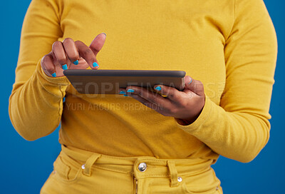 Buy stock photo Hands, tablet and search with a woman on a blue background in studio for research on the internet. Social media, tech and 5g with a female user reading data or information online for connectivity
