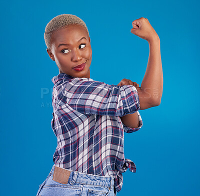 Buy stock photo Young black woman flex arms in studio, blue background and backdrop of freedom, empowerment or pride. Female model, bicep and girl power in fight for gender equality, strong muscle or feminism leader