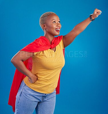 Buy stock photo Black woman, superhero cape and flying in studio, blue background and pop culture fashion. Happy female model, cosplay character and superwoman costume of fist, courage or action of strong girl power