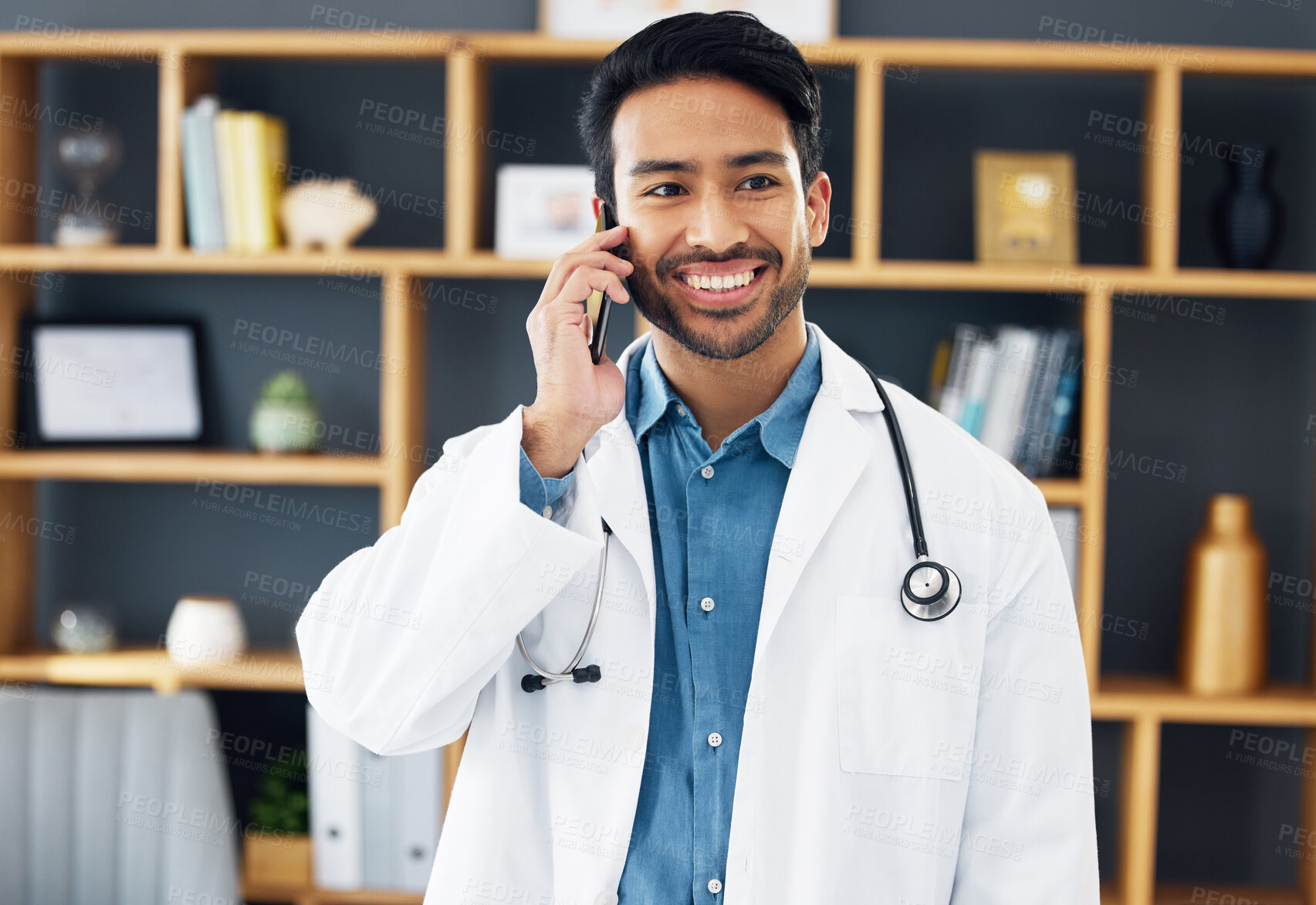 Buy stock photo Asian man, doctor and phone call with smile for healthcare consulting, conversation or chat at hospital. Happy male medical expert smiling on mobile smartphone in communication or health consultation