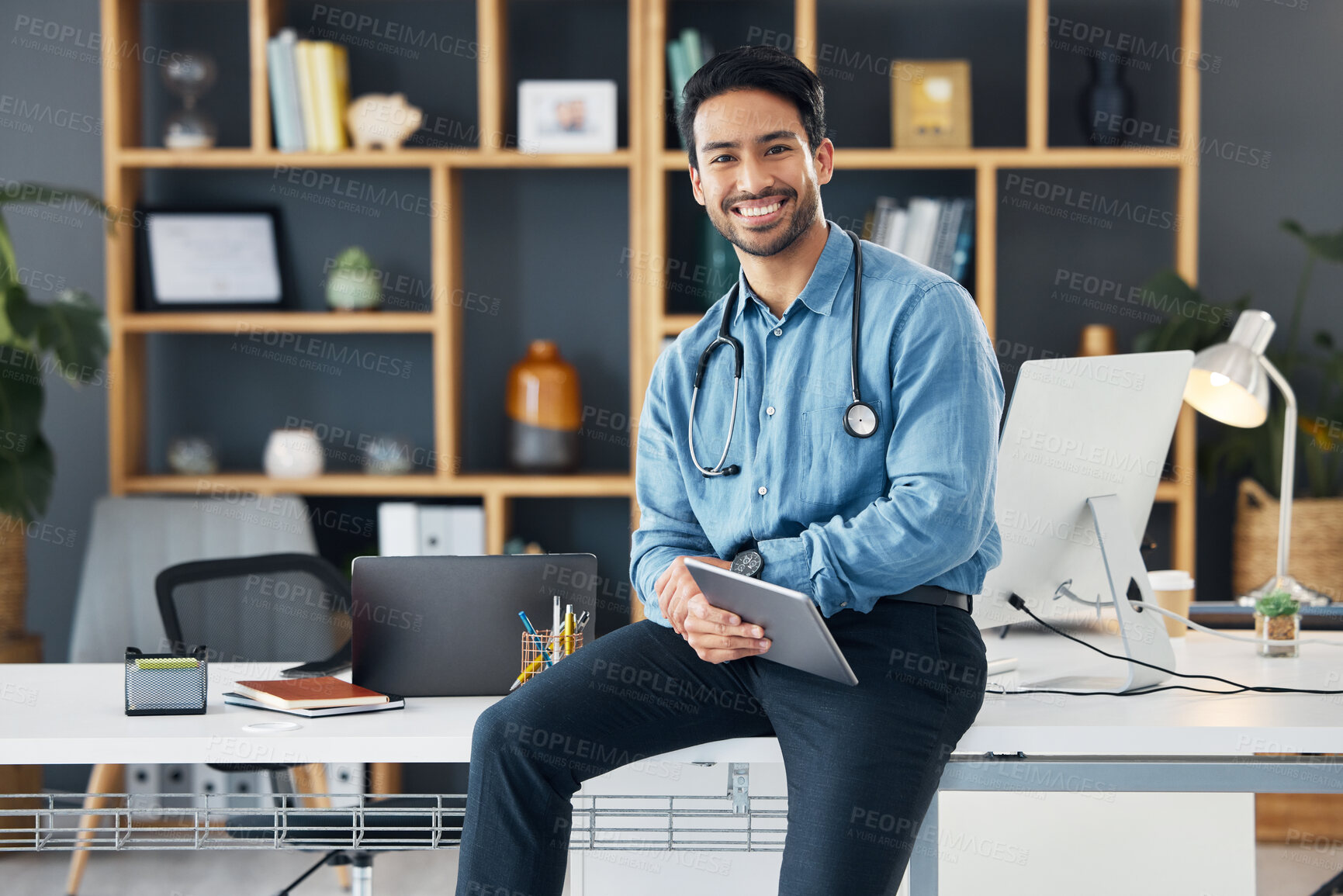 Buy stock photo Relax, tablet and portrait of healthcare professional holding device for internet, web and online connection in a office. Medical, smile and happy man doctor sitting on table or desk is satisfied