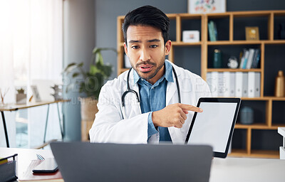 Buy stock photo Mockup, pointing and a doctor on a video call with a tablet for results, healthcare support and advice. Talking, consulting and an Asian gp with a blank screen tech for a telehealth webinar on a pc
