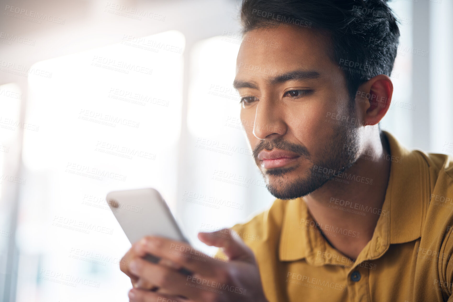 Buy stock photo Serious asian man, phone and social media for communication or networking at home. Focused male freelancer face on mobile smartphone app for chatting, texting or browsing on internet or research