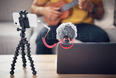 Buy stock photo Laptop, phone and music influencer, man with ukulele on sofa, webinar recording and live streaming in home. Internet, webcam and online content creation equipment for social media tutorial channel.