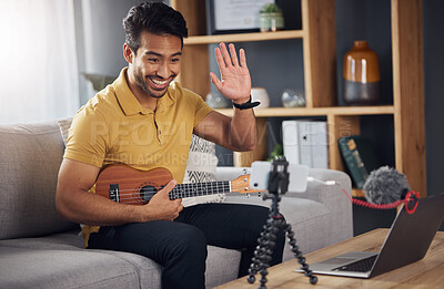 Buy stock photo Podcast, guitar and laptop with a man online to wave and coach during live streaming lesson. Asian male person happy on home sofa with a ukulele as content creator teaching music on education blog