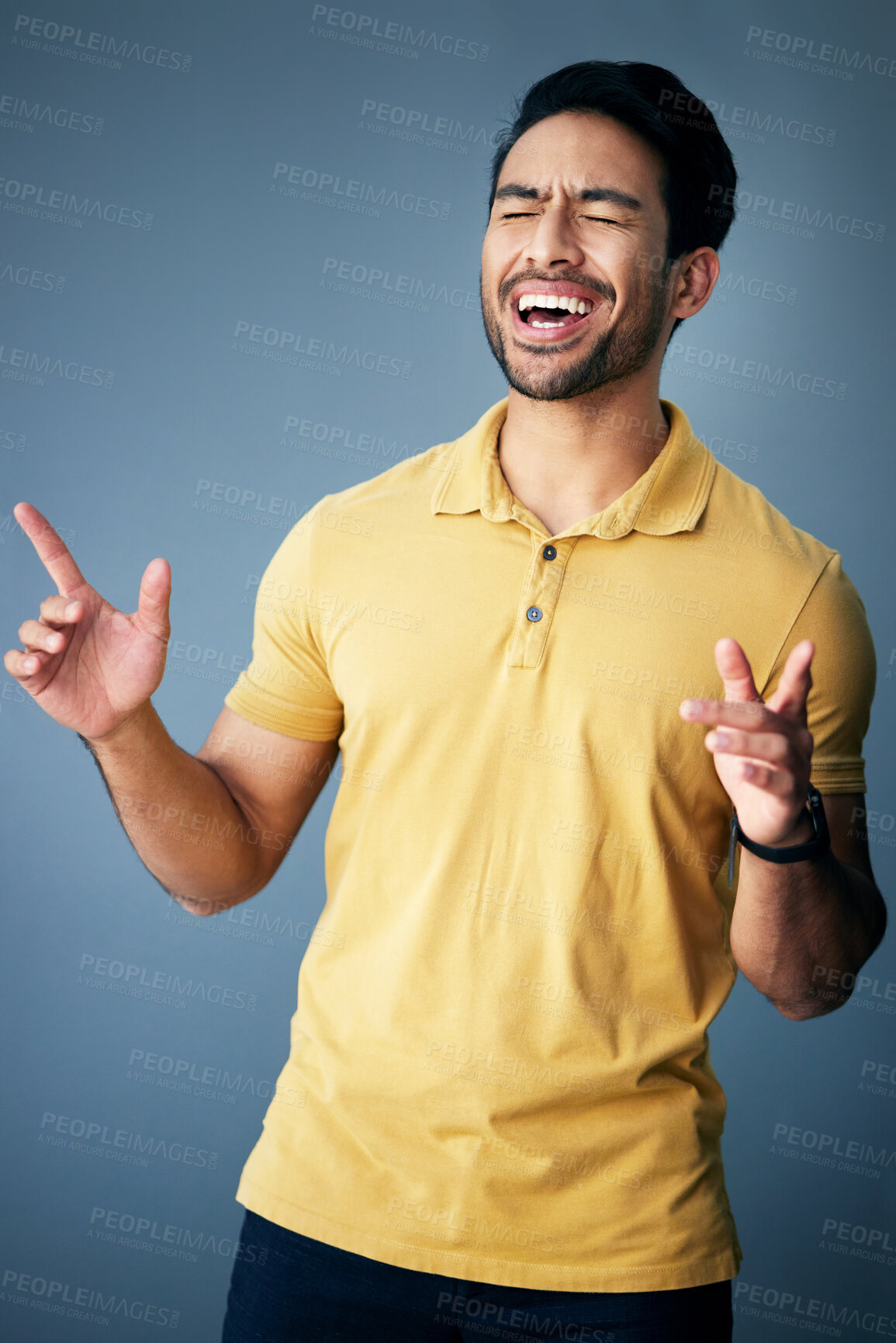 Buy stock photo Karaoke, happy and a singing Asian man with a song isolated on a grey background in a studio. Smile, sing and a Japanese singer or artist enjoying, expressing and giving entertainment on a backdrop