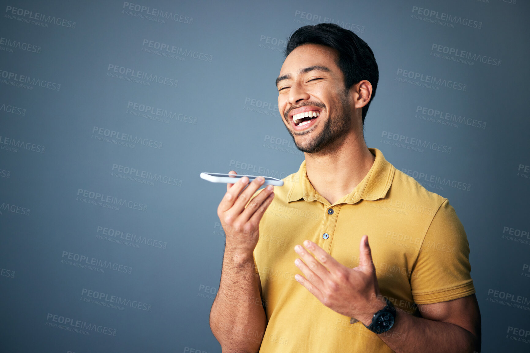 Buy stock photo Mockup, phone call and Asian man with speaker, funny and guy laughing against a studio background. Japan, male and gentleman with cellphone, humor and conversation with joy, cheerful and connection