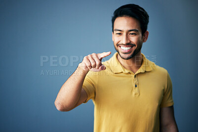 Buy stock photo Mockup, smile and Asian man pointing, space and product placement against blue studio background. Japan, male and happy guy with brand development, happiness and suggestion with promotion and choice