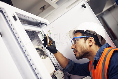 Buy stock photo Electrician, engineer and maintenance man with screwdriver in control room for power box. Male technician person for inspection service for engineering, electricity or energy supply repair with torch