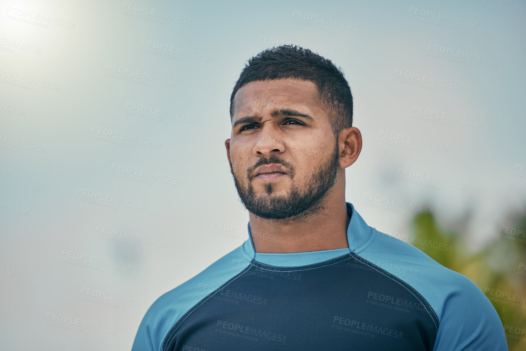 Buy stock photo Sport, sky and man with serious expression, confidence and pride in winning game with focus. Fitness, sports and dedication, rugby player at match, workout or competition at stadium in New Zealand.