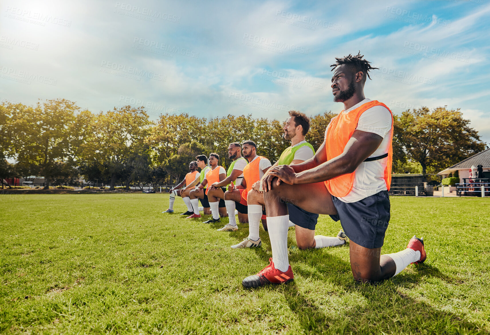 Buy stock photo Sports, training and team outdoor for rugby on a grass field with men doing knee exercise. Athlete group together for fitness and workout for professional sport with diversity, support and teamwork