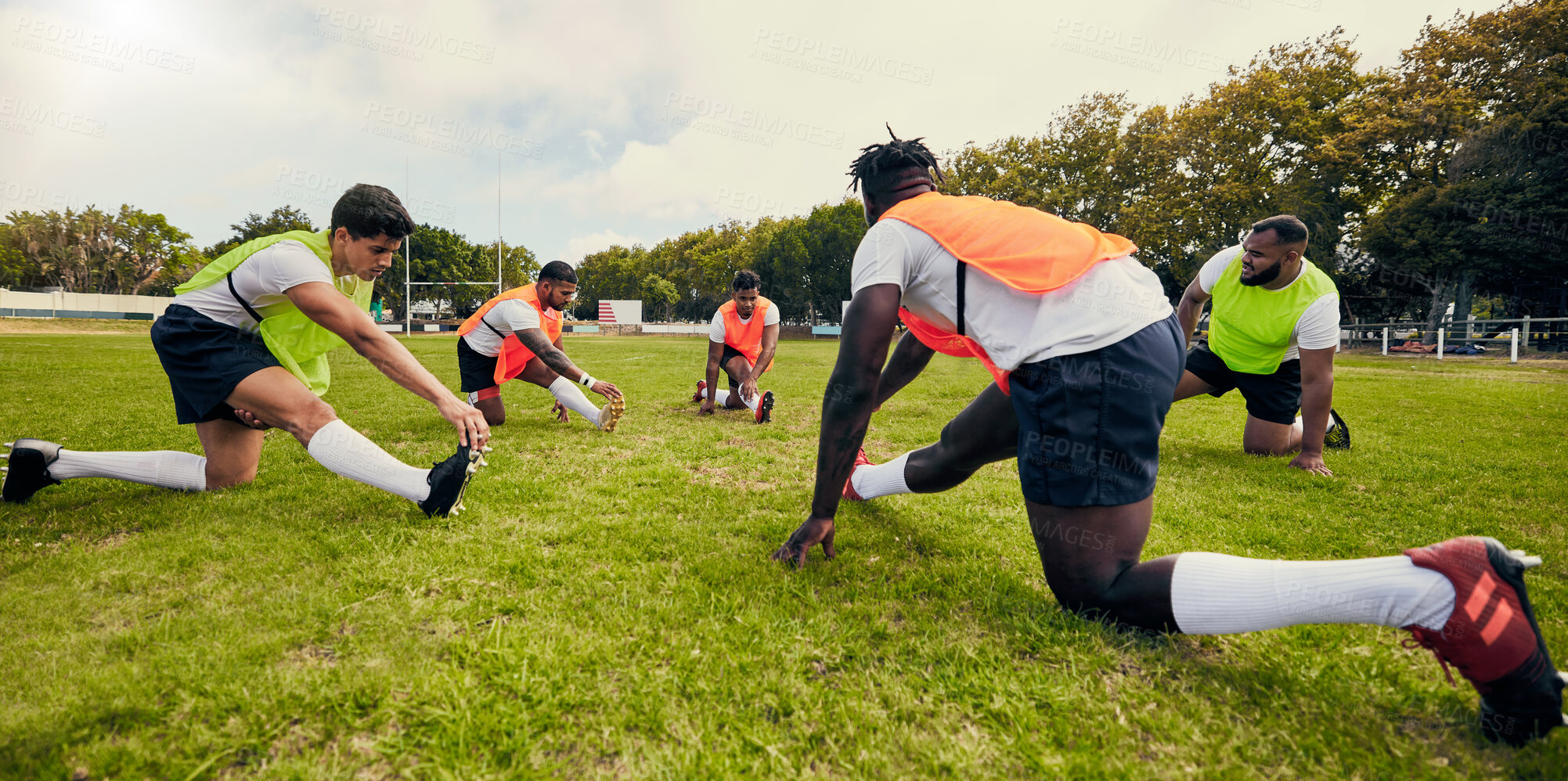 Buy stock photo Sports, training and men outdoor for rugby on grass field with diversity team stretching as warm up. Athlete group together for fitness, exercise and workout for professional sport or teamwork energy