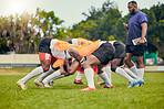 Rugby, scrum or men training with coach on grass field ready for match, practice or sports game. Fitness, performance or strong athletes in tackle for warm up, exercise and workout for a competition