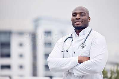 Buy stock photo African, man and doctor in city for portrait, arms crossed and smile for wellness, healthcare and mockup. Young black medic, confidence and happy in metro with blurred background for mock up space