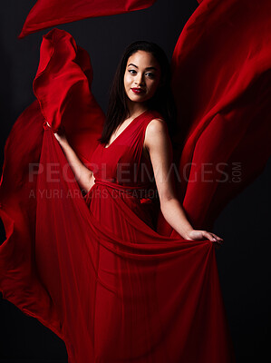 Buy stock photo Portrait of woman, art and fashion, fabric on dark background with beauty and aesthetic movement. Flowing silk motion, fantasy and artistic model with smile in red creative designer dress in studio.