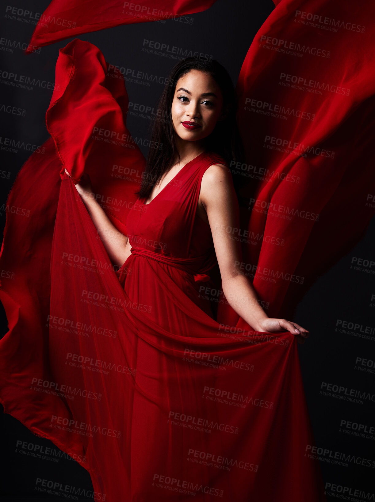 Buy stock photo Portrait of woman, art and fashion, fabric on dark background with beauty and aesthetic movement. Flowing silk motion, fantasy and artistic model with smile in red creative designer dress in studio.