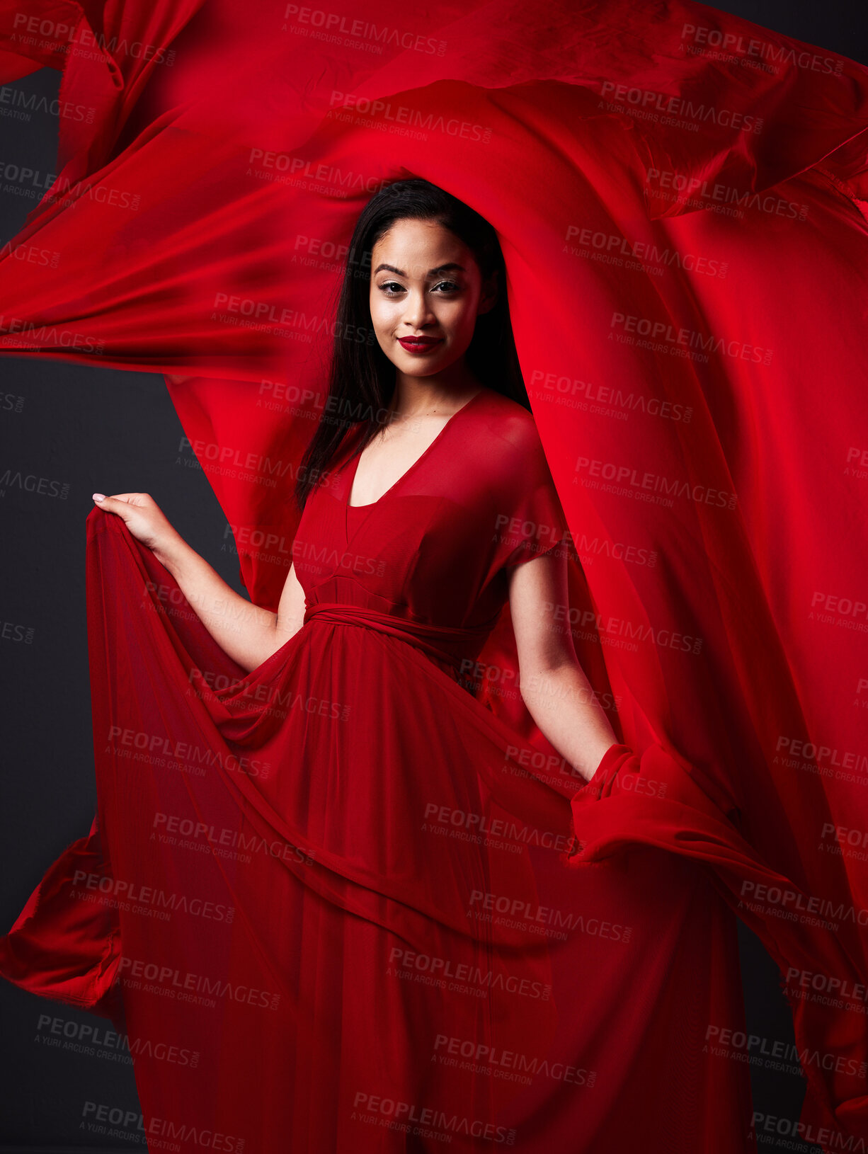 Buy stock photo Woman, art and fashion, red fabric on dark background with beauty and aesthetic movement. Flowing silk motion, fantasy and artistic portrait of model with smile in designer dress and veil in studio