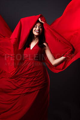 Buy stock photo Woman, beauty and fashion, red art on dark background with energy and aesthetic movement. Flowing silk motion, fantasy and artistic model with smile in creative fabric designer dress in studio