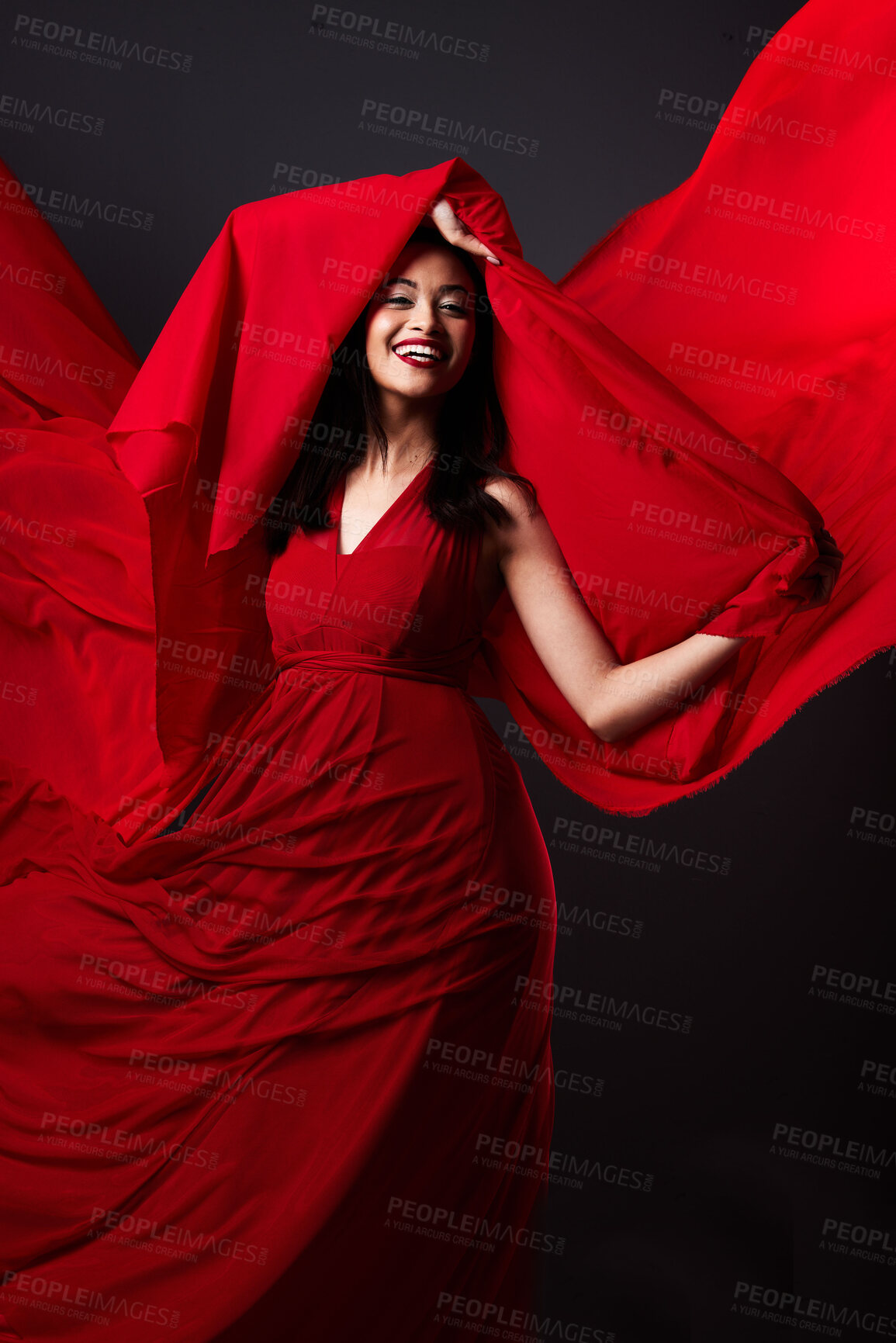 Buy stock photo Woman, beauty and fashion, red art on dark background with energy and aesthetic movement. Flowing silk motion, fantasy and artistic model with smile in creative fabric designer dress in studio