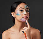 Skin, art and portrait of woman with face paint, creative makeup and self expression. Beauty, creativity and color in artistic cosmetics, empowerment and freedom to express for young beautiful girl.