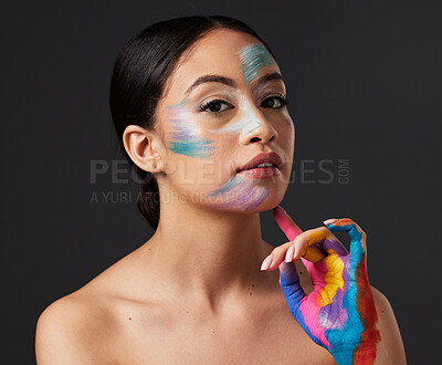 Buy stock photo Woman, beauty and portrait with rainbow hand paint art on face in studio with glow. Creative skin and makeup on female aesthetic model serious on gray background for lgbtq color inspiration on hands