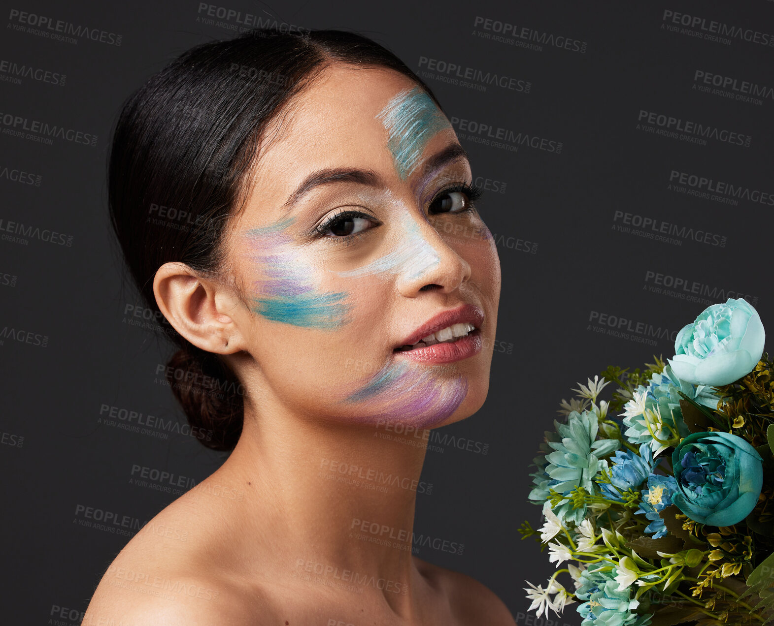 Buy stock photo Beauty, woman and face paint with makeup, art with flowers and colorful aesthetic, color stroke in portrait on studio background. Skin, glow and cosmetics with creativity and female with smile