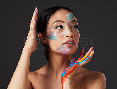 Buy stock photo Beauty, art and woman with paint on face and hands, creative makeup and self expression. Aesthetic, creativity and artistic color cosmetics, skincare and freedom to express for young beautiful girl.