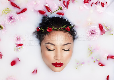 Buy stock photo Beauty, milk and flowers with woman in bath for spa treatment, relax and skincare. Wellness, cosmetics and pampering with female and rose petals from top view for grooming, satisfaction and self care