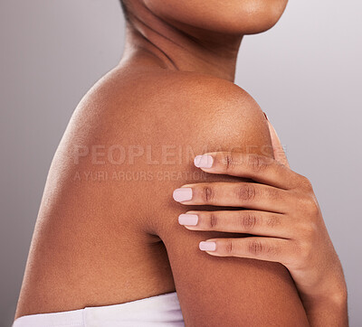 Buy stock photo Woman, hands and shoulder in skincare beauty, cosmetics or body care against a gray studio background. Hand of female touching shoulders in cosmetic treatment for self love or soft and perfect skin