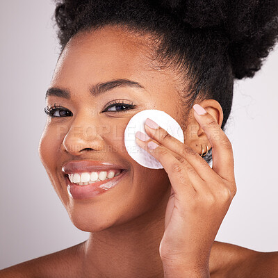 Buy stock photo Black woman, cotton and skincare in studio with smile in headshot, cleaning or makeup removal by background. Young model, wipe and clean for natural glow, wellness and cosmetic beauty for self care