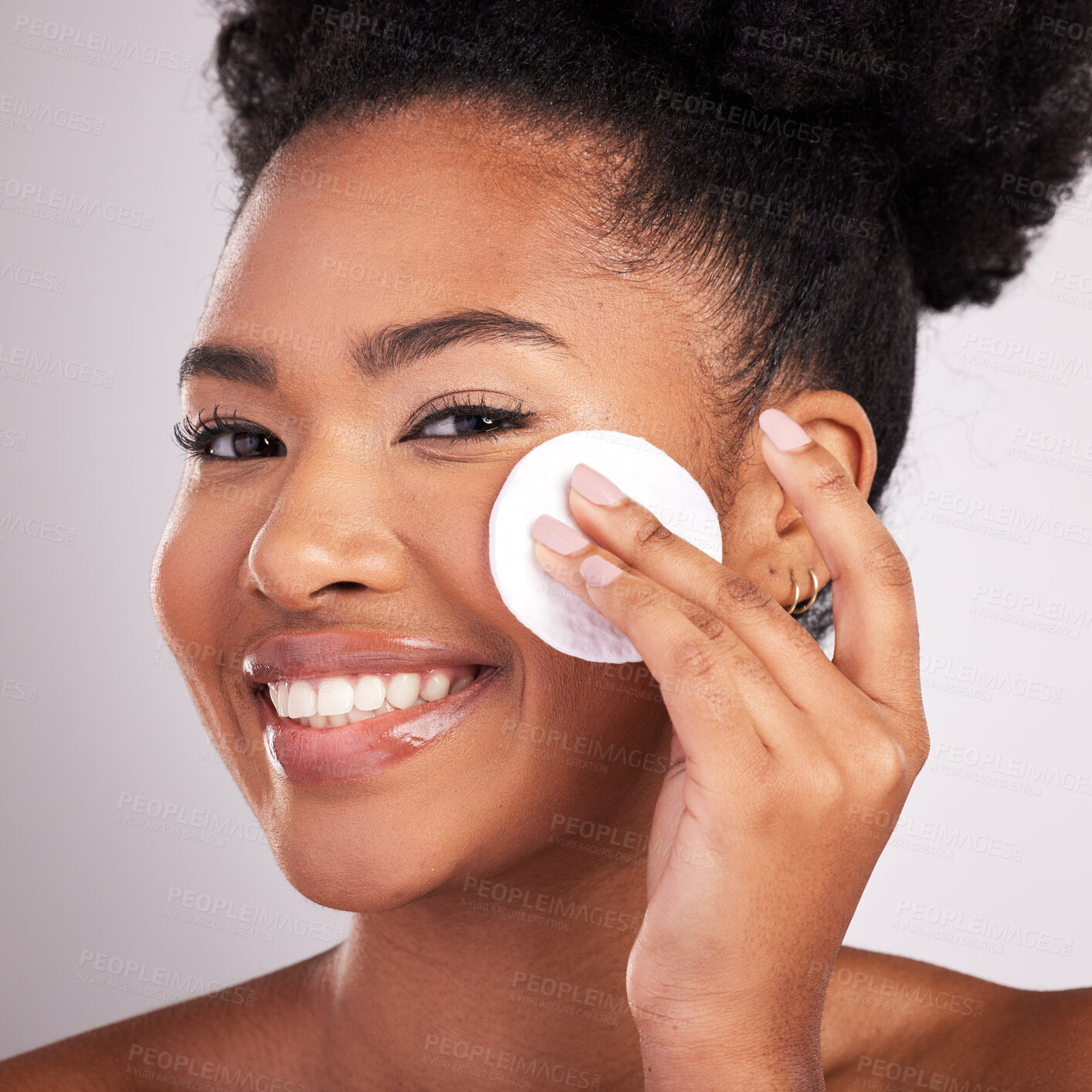 Buy stock photo Black woman, cotton and skincare in studio with smile in headshot, cleaning or makeup removal by background. Young model, wipe and clean for natural glow, wellness and cosmetic beauty for self care