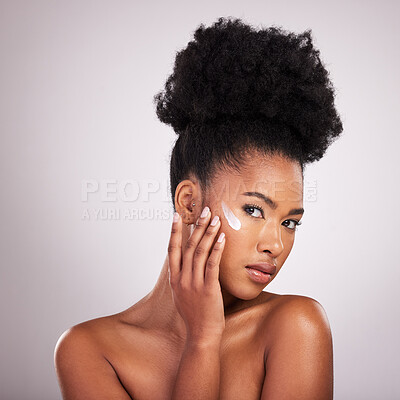 Buy stock photo Black woman, face and moisturizer cream for skincare beauty or cosmetics against a gray studio background. Portrait of African American female applying moisturizing creme, lotion or facial product