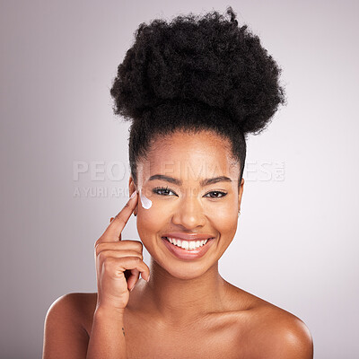 Buy stock photo Black woman, face and moisturizer cream for skincare beauty or cosmetics against a gray studio background. Portrait of happy African female with smile for moisturizing creme, lotion or facial product