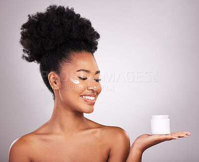Buy stock photo Black woman, moisturizer cream and smile for skincare beauty or cosmetics against a gray studio background. Happy African female smiling and holding moisturizing creme, lotion or facial product