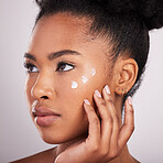 Skincare, beauty and black woman with cream on face for anti aging or fresh skin glow on white background. Cosmetics, facial and lotion, African model with moisturizer or cleansing product in studio.