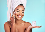 Skincare, lotion and black woman with jar, cream for anti aging and fresh skin glow on blue background. Cosmetics, facial and African model with moisturizer or cleansing product in hand in studio.