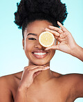 Black woman, face and smile with lemon for skincare nutrition, beauty or vitamin C against studio background. Portrait of African American female smiling with fruit for natural health and wellness