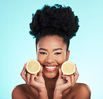 Lemon, portrait and beauty of happy black woman in studio, blue background or vegan wellness. Happy model, citrus fruits and smile of facial cosmetics, vitamin c skincare or natural detox dermatology