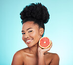 Grapefruit, skincare and woman portrait of beauty, wellness and detox healthcare. Isolated, blue background and studio with a young female feeling happy from healthy food with vitamin c for glow
