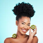 Kiwi fruit, skincare and woman portrait of beauty, wellness and detox healthcare. Isolated, blue background and studio with a young female feeling happy from healthy food with vitamin c for glow