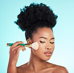 Makeup, cosmetics brush and face of black woman for beauty, glamour and facial treatment on blue background. Salon, cosmetology and girl with brushes for foundation, skincare or application in studio