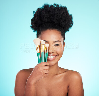 Buy stock photo Makeup brushes, cosmetics and portrait of black woman for beauty, glamour and facial on blue background. Salon, cosmetology and face of happy girl for foundation, skincare and application in studio