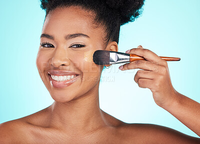 Buy stock photo Black woman, foundation and brush in studio for beauty with skin test, smile and cosmetics by blue background. Happy african model, girl and makeup for aesthetic, glow and skincare with concealer