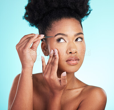 Buy stock photo Beauty, hair removal and eyebrows with black woman and tweezer in studio for cosmetics, grooming and self care. Spa, growth and aesthetic with model on blue background for natural, fresh and shaping