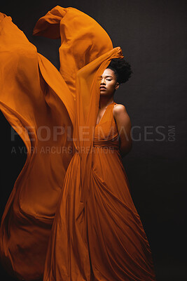 Buy stock photo Black woman, wind and art in fashion, fabric on dark background and motion in aesthetic movement. Flowing silk, fantasy and artistic beauty, sensual African model in creative designer dress in studio